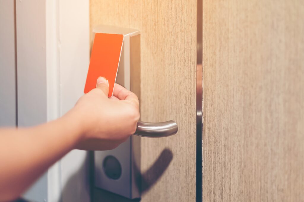 Closeup hand girl opens the door Hotel with electronic card lock