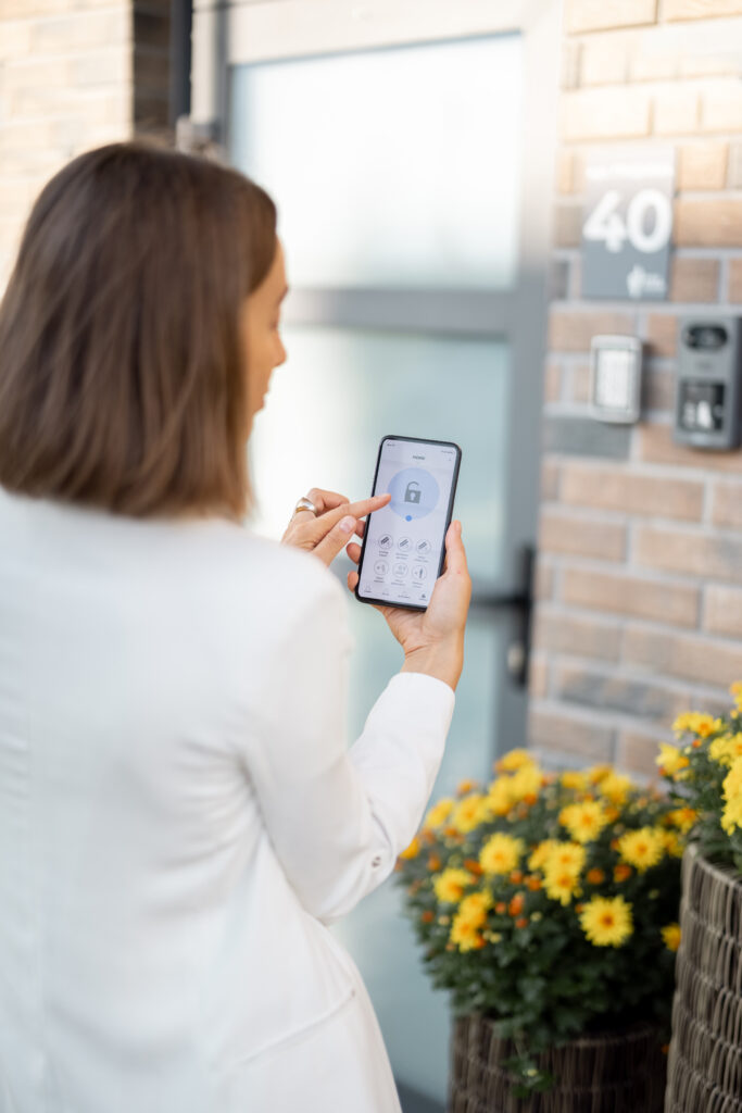 Female closes the door or turns on the house alarm with phone